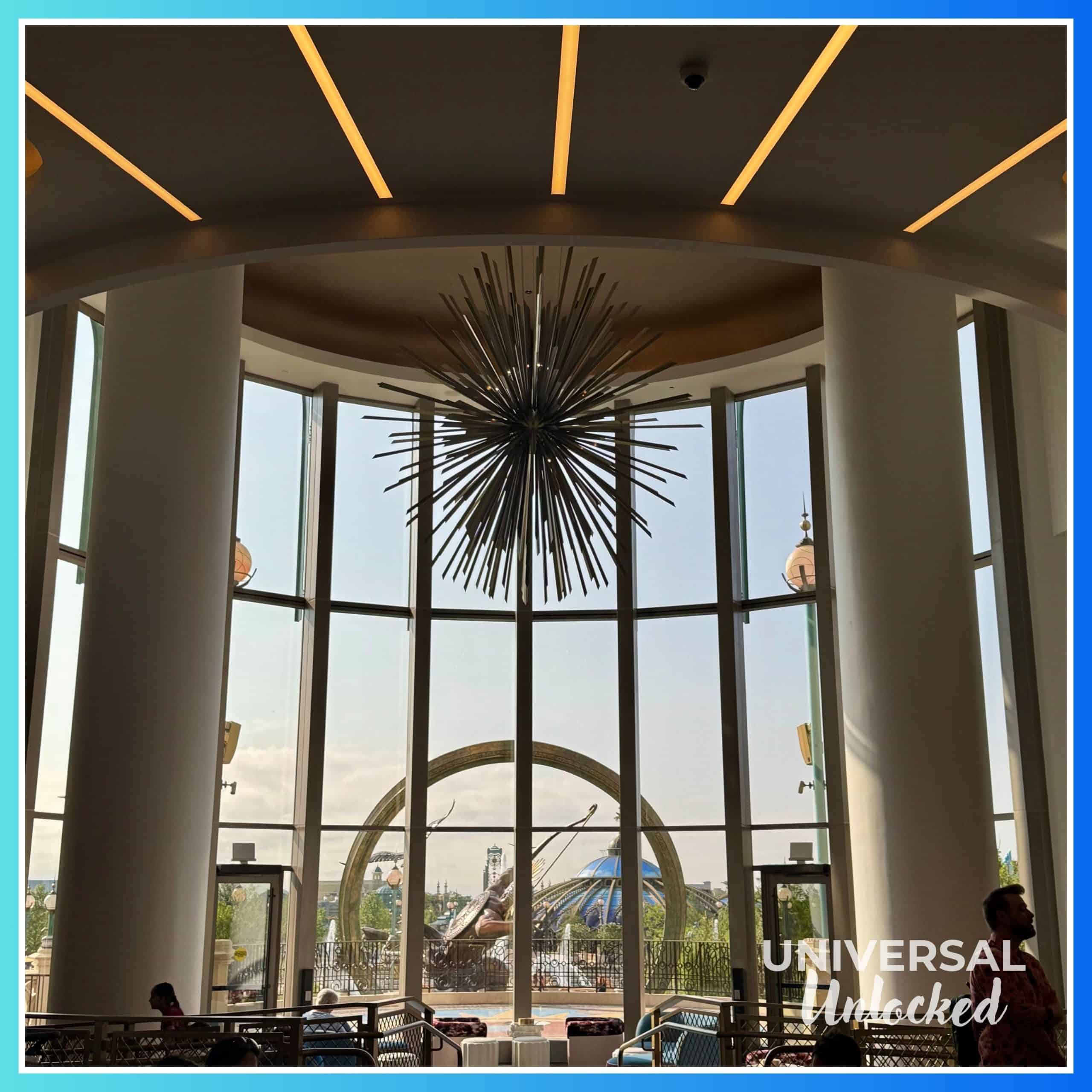 Lobby at the Helios Grand Hotel looking out over the patio and EPIC Universe