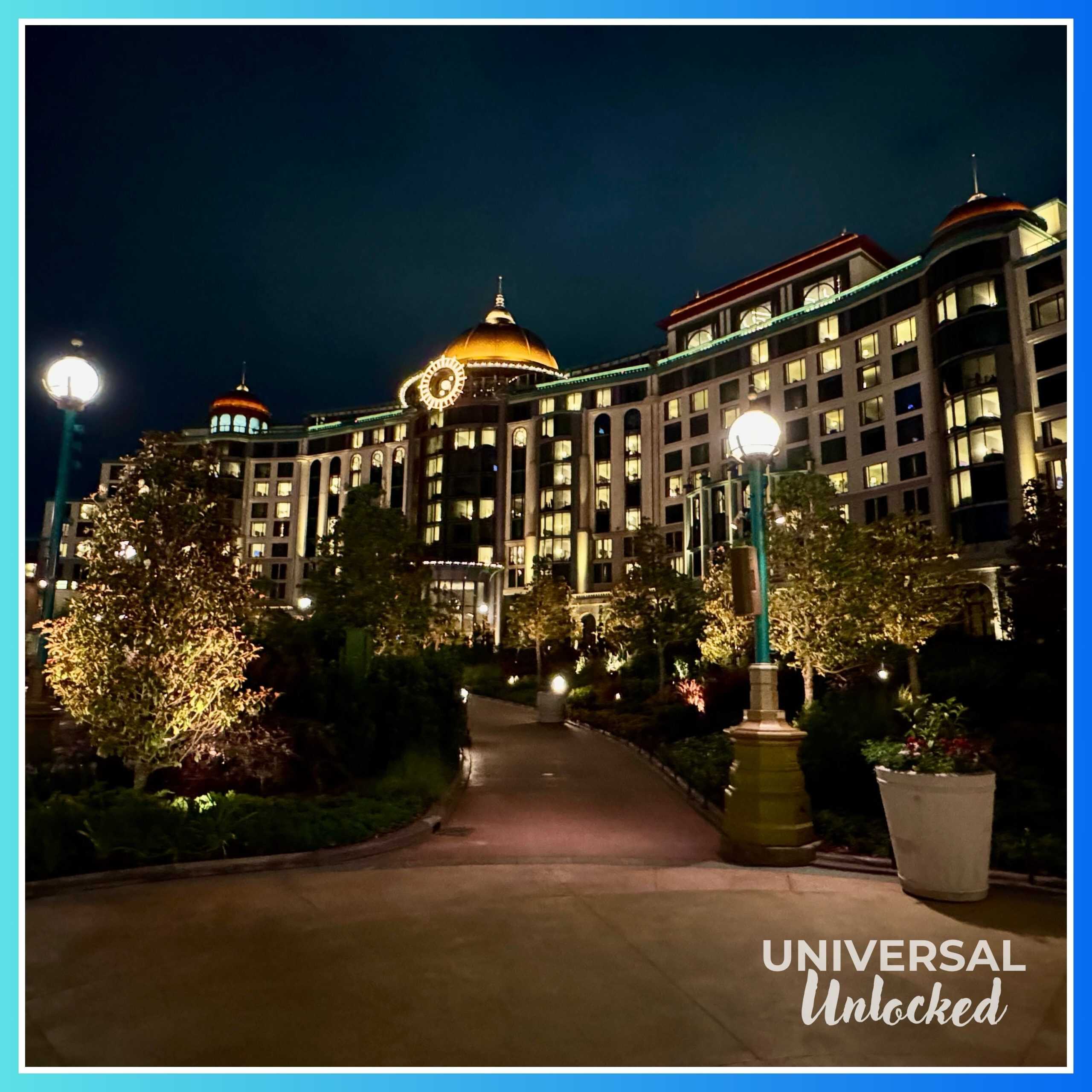 View of the Helios Grand Hotel at night from inside EPIC Universe