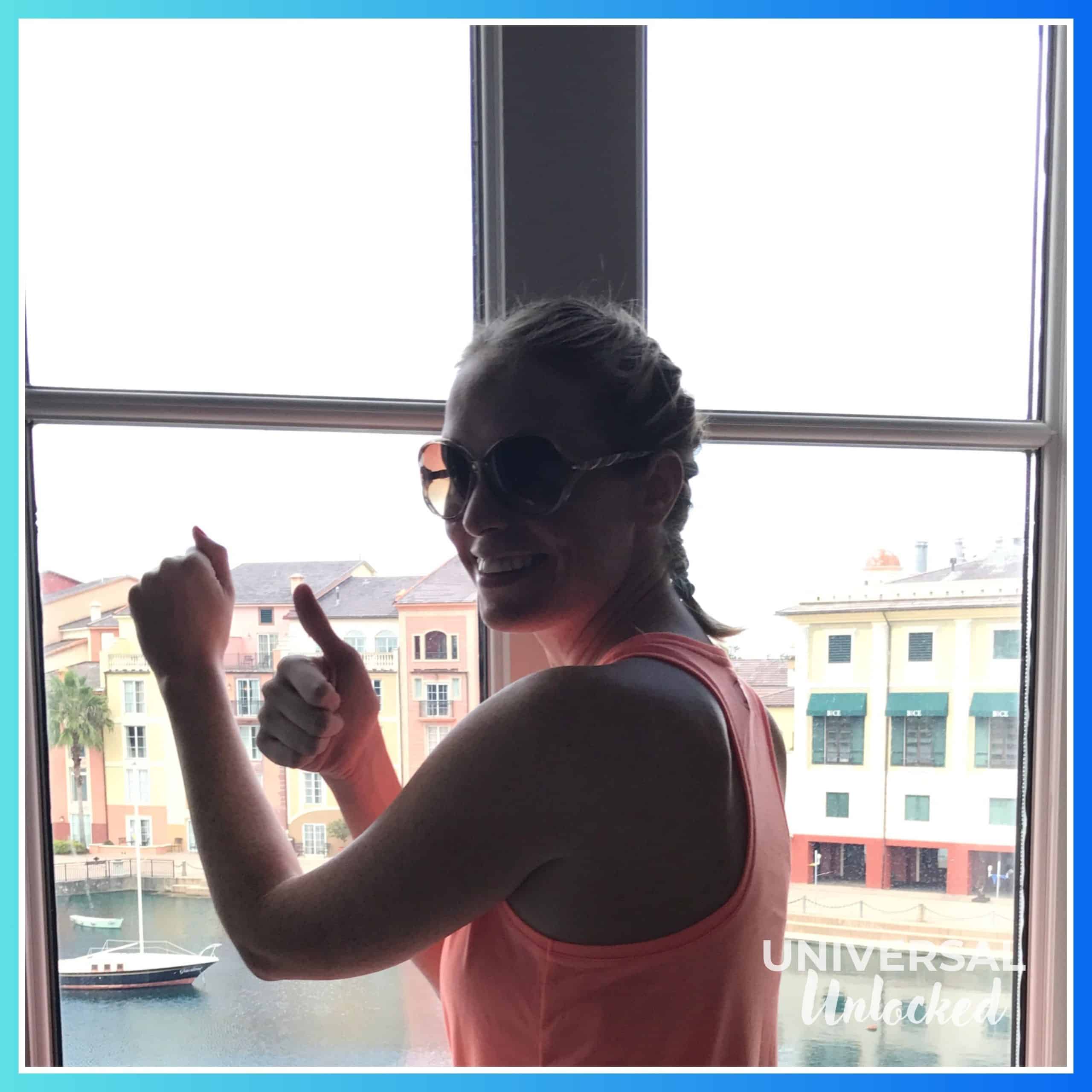 Laney checking the hurricane proof windows in 2017 in a Portofino Bay Hotel guest room